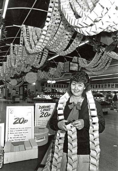 Norco assistant Susan Brown with the charity chain fundraiser for Grampian Cancer Care in 1990