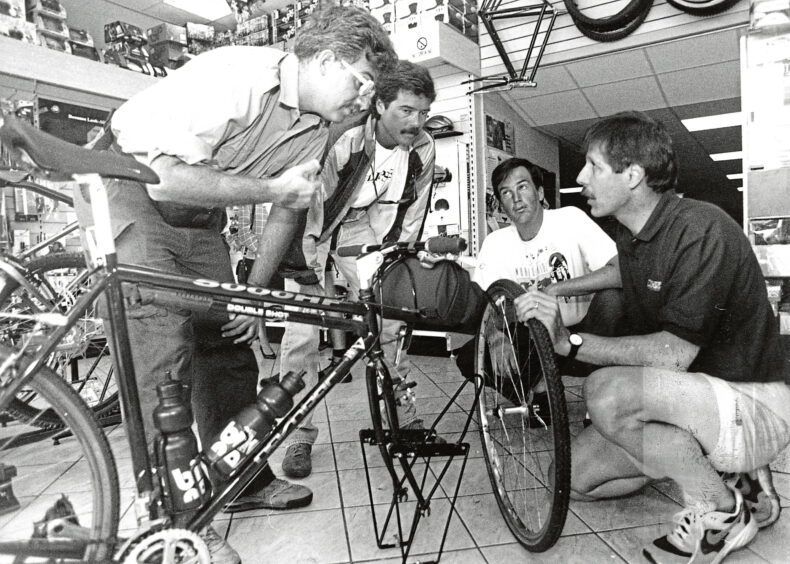 John Dean of Cycling World, Aberdeen helps cyclists Peter McIntyre, Geff Ebert and Richard Drorbaugh in the shop in 1993