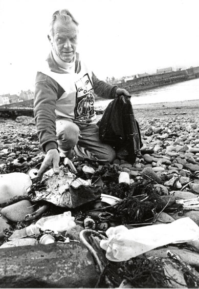 Alex Clark picking up rubbish at Stonehaven Harbour during the UK's National Spring Clean in 1993