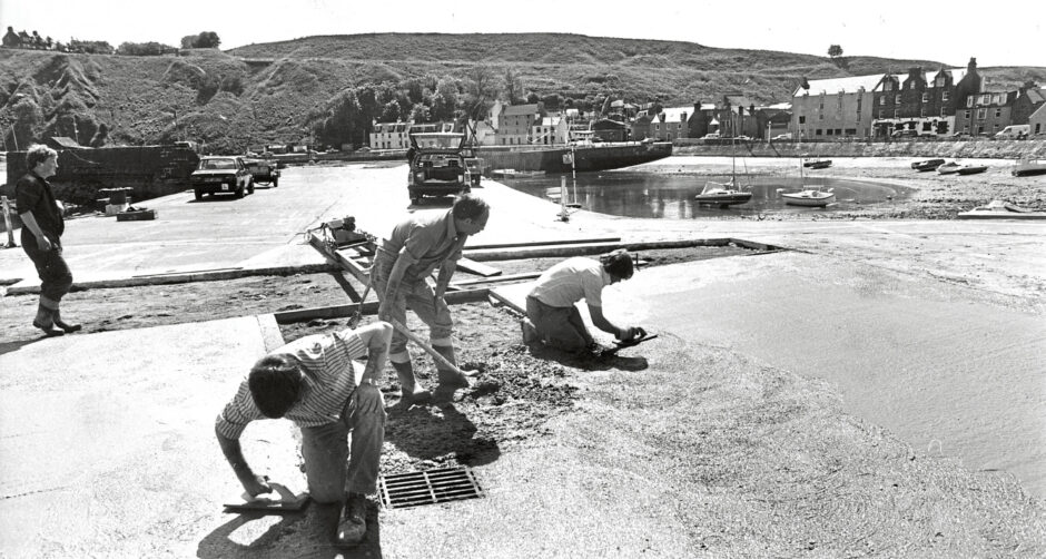 Council workmen repairing the concrete surface at Stonehaven harbour in 1988
