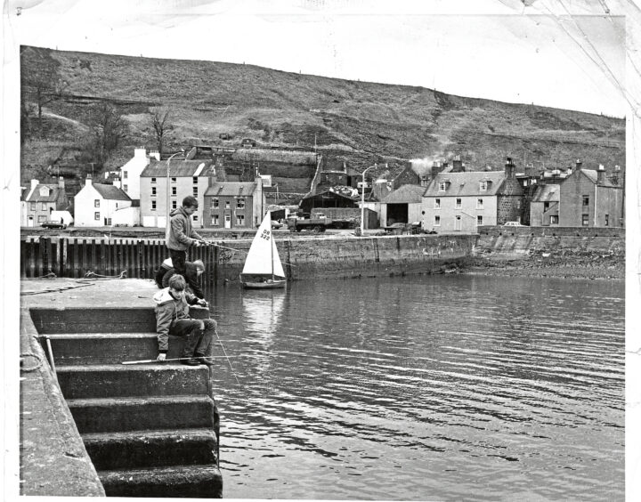 Two boys fishing in Stonehaven harbour in 1968