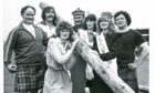 Aberdeen Festival queen Kathleen Gauld, left, and her two princesses Anne Anderson, centre, and Kay Craigmile try their hand at lifting the caber – with a little help from some of the heavyweights taking part in 1979
