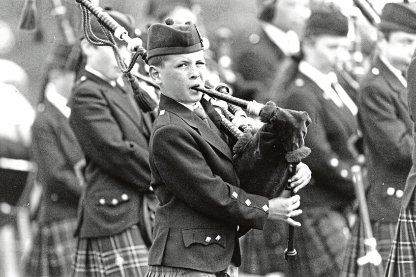 A young piper takes part in the parade of massed pipe bands at the Aberdeen Highland Games in 1993