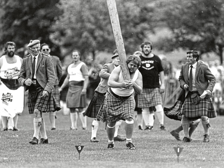 A competitor loses control of caber and it topples towards an official at the Aberdeen Highland Games in 1988