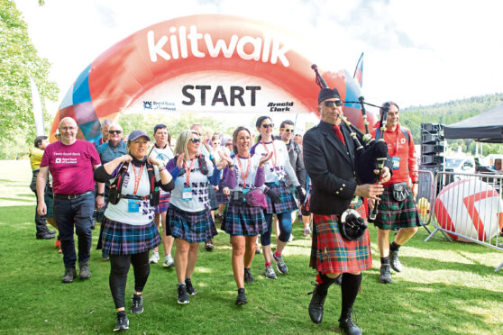 An image of a group of people who have finished the Kiltwalk and crossed the finish line.