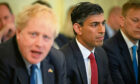 Chancellor of the Exchequer Rishi Sunak listens as Prime Minister Boris Johnson chairs a Cabinet meeting at 10 Downing Street, London, after he survived an attempt by Tory MPs to oust him as party leader following a confidence vote in his leadership at the Houses of Parliament.