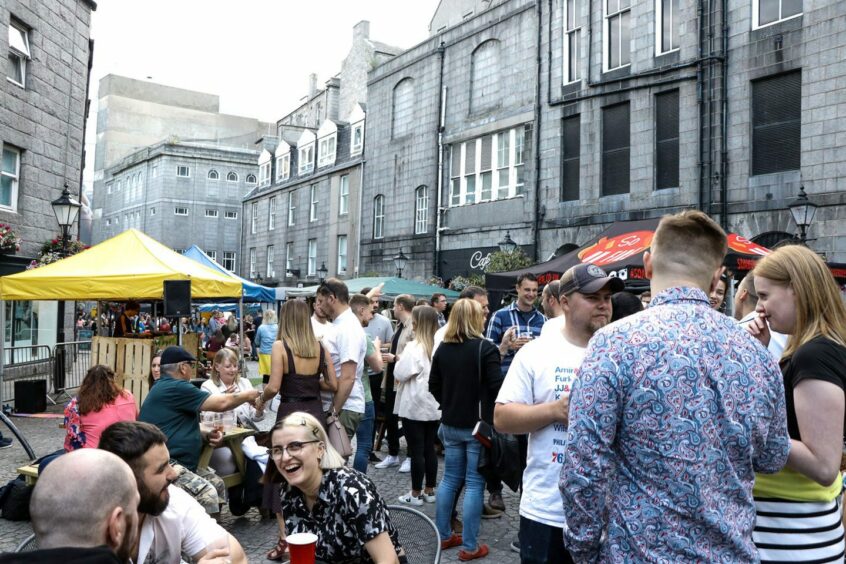 A crowd of people at street food market Inspired Nights on The Green in Aberdeen.