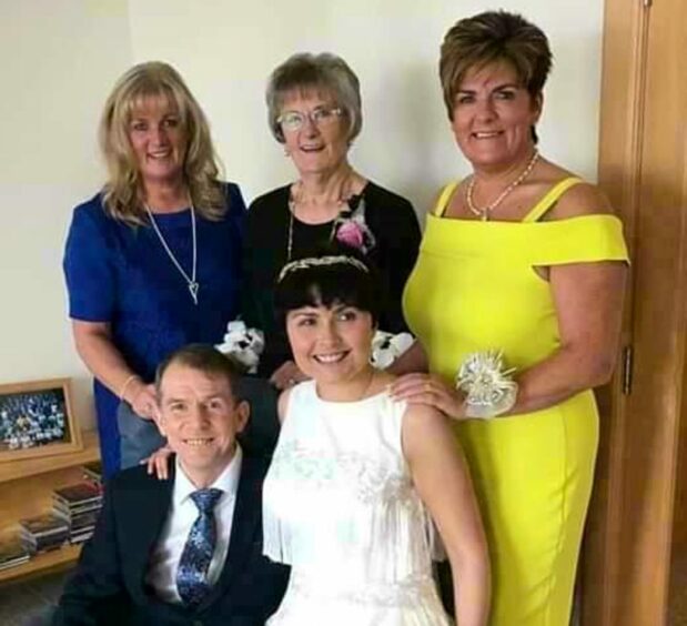 Iain and Michelle with loved ones on their wedding day