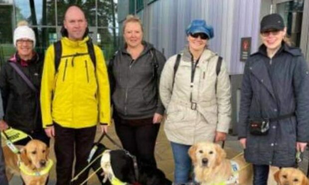 Angela Clelland (centre) with her walking group set up for those with visual impairment in Inverness.