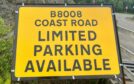 Highland council, B8008 sign says "coast road, limited parking available"