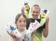 CR0036259
Local entrepreneur Cameron Robbie will be donating more than 30 pairs of specially designed shoes to Charlie House children at the charity's HQ on Carden Place. 
Pictured is brother and sister, Ayla Penny aged 9 and Brody Penny aged 12 from Aberdeenshire with their shoes.
Pic by Chris Sumner
Taken..............10/06/22