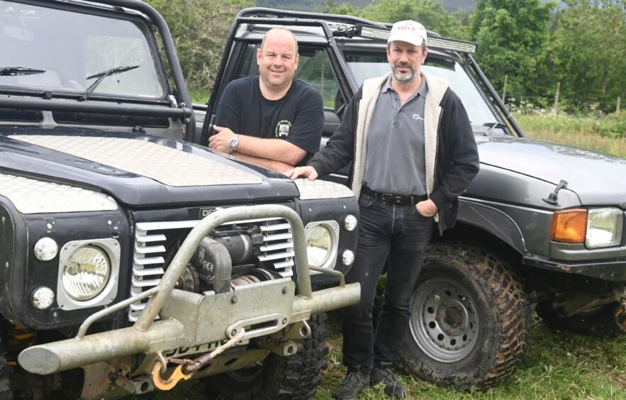 Alistair with brother Andy Tong standing with their Land Rovers