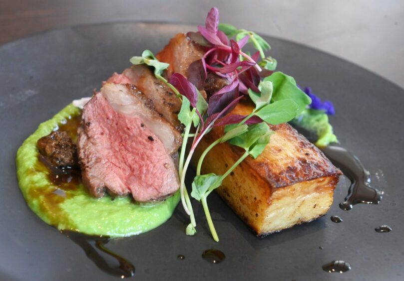 Roast lamb with peas, trumpet mushrooms and fondant potato with a port reduction.