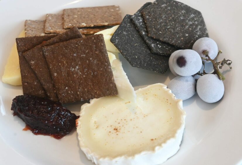 Scottish cheeseboard with artisan biscuits and frozen grapes.