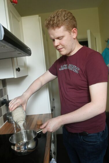 The 26-year-old preparing a meal with the rations