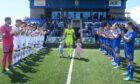 Stuart McKenzie, centre, with his children receives a guard of honour before Cove Rangers played Dunfermline