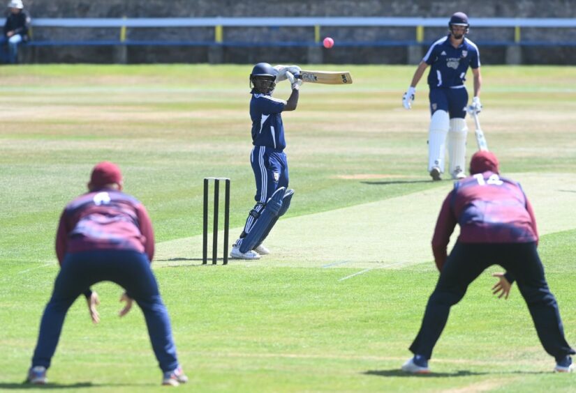 Aberdeenshire's Aayush Dasmahapatra sends the ball between Watsonians fielders Douglas Voas and Oliver Hairs.