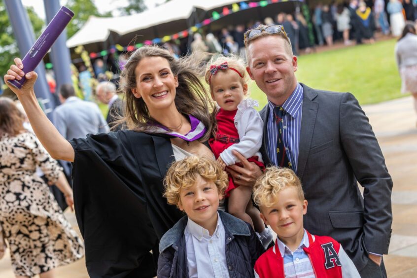 BSc (Hons) Psychology graduate celebrating with her family at her graduation ceremony