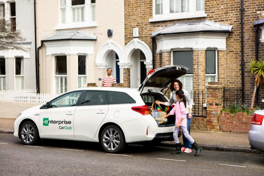 a family loads their luggage into a car for hire in Aberdeen's Enterprise Car Club