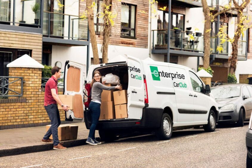 a man and a woman put boxes into a van for hire in Aberdeen's Enterprise Car Club
