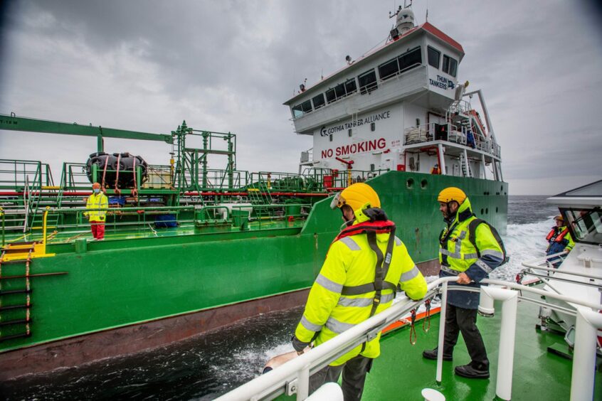 people on board two vessels work in the high seas near Orkney Islands