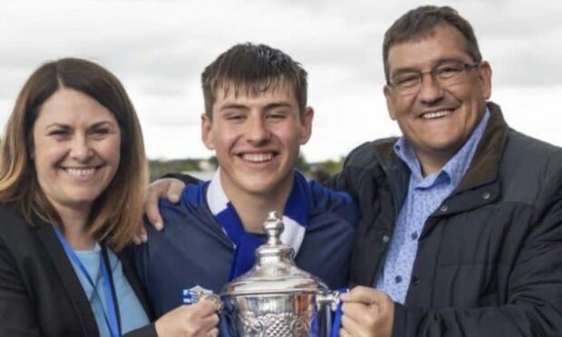 Fraserburgh's Ethan Sutherland with parents Lorraine and Graeme pictured with the Scottish Youth FA Cup won this year with Dyce Boys Club.