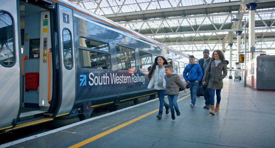 A family getting on a train at South Western Railway