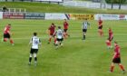 Fraserburgh's Aidan Combe goes on the attack against Inverurie Locos.
