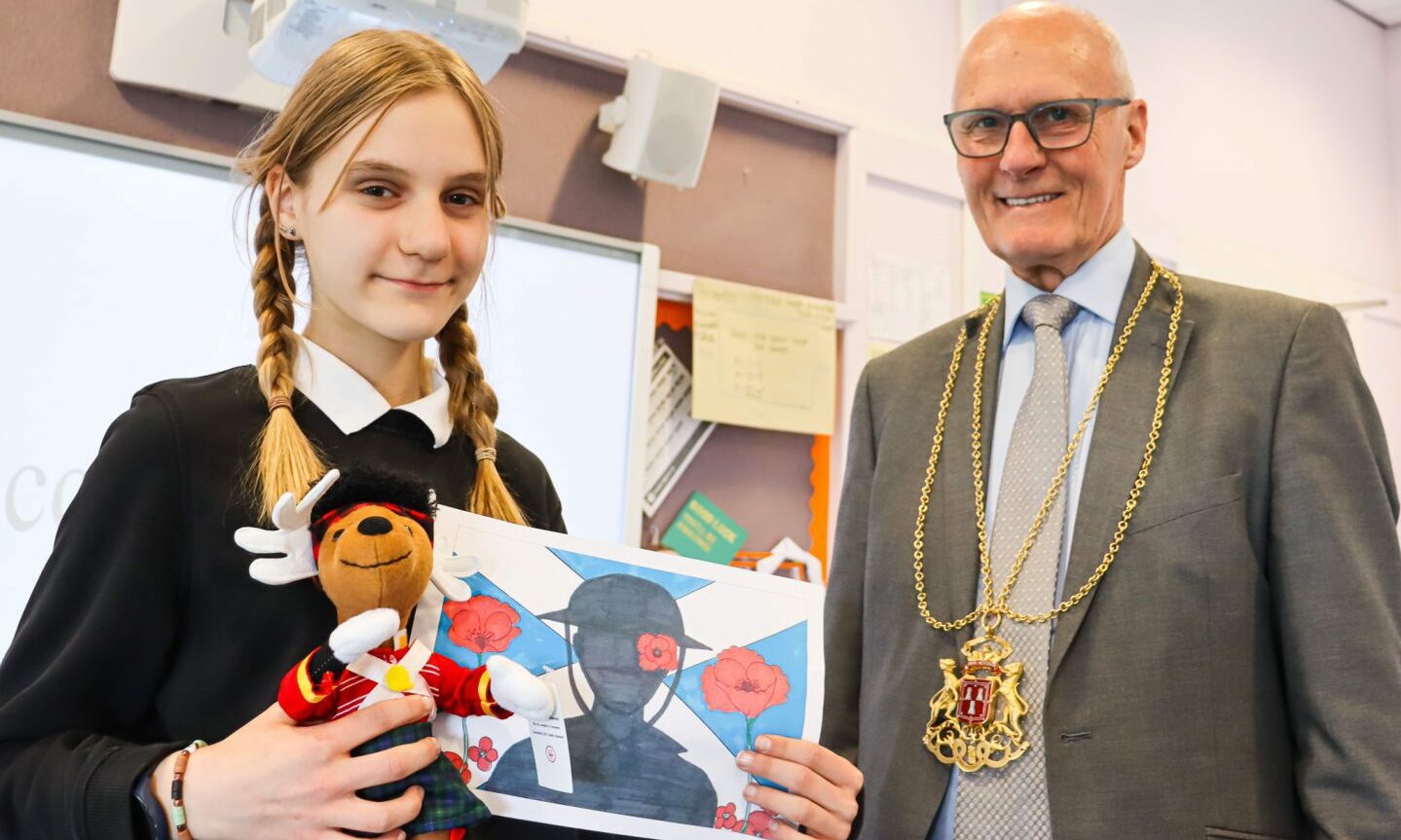 Zuzanna Bolkowska, 12, designed the flag which will be handed out at the parade. She is pictured with Lord Lieutenant David Cameron. Supplied by Aberdeen City Council.