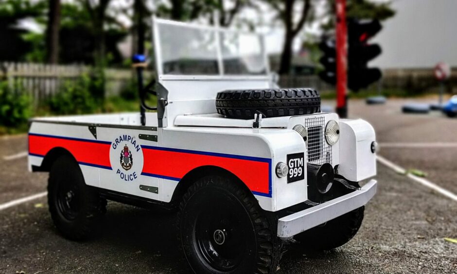 One of the electric cars with "Grampian Police" written on the side.