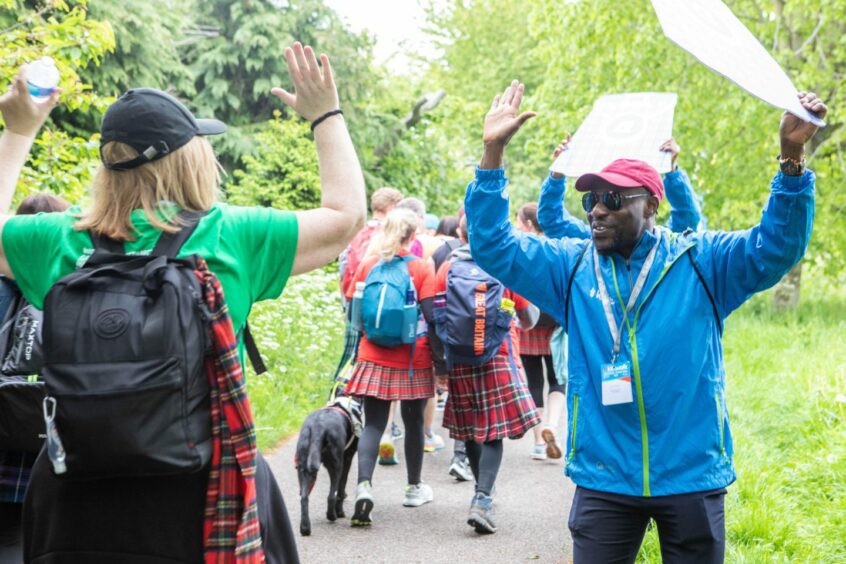 People walking in kilts during the Friends of Anchor Kiltwalk