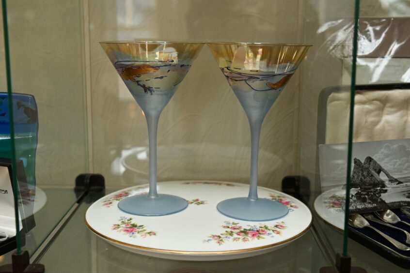 Antique margarita glasses in a glass case in Lynash Antiques