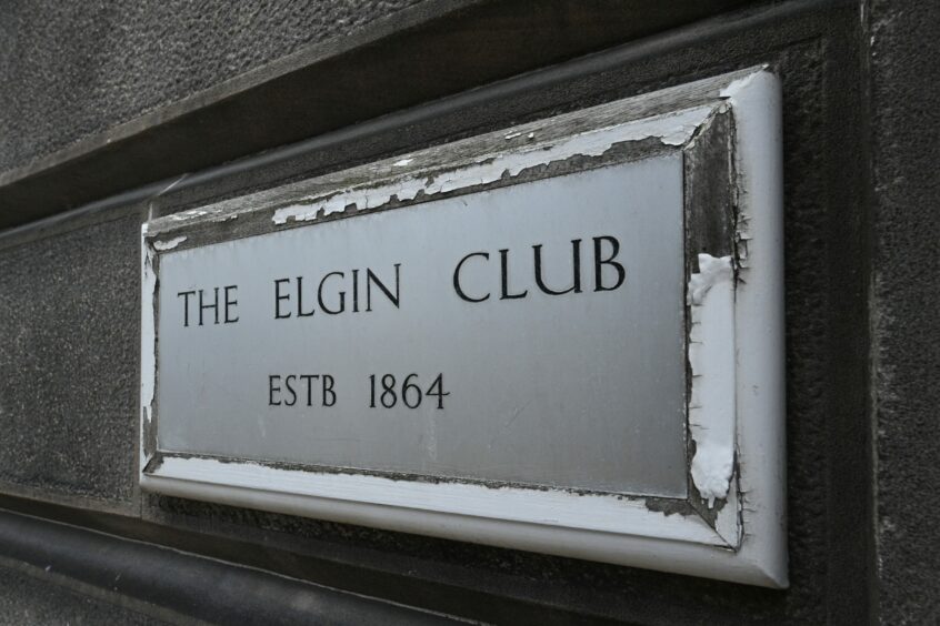 A plaque reading 'The Elgin Club ESTB 1864'