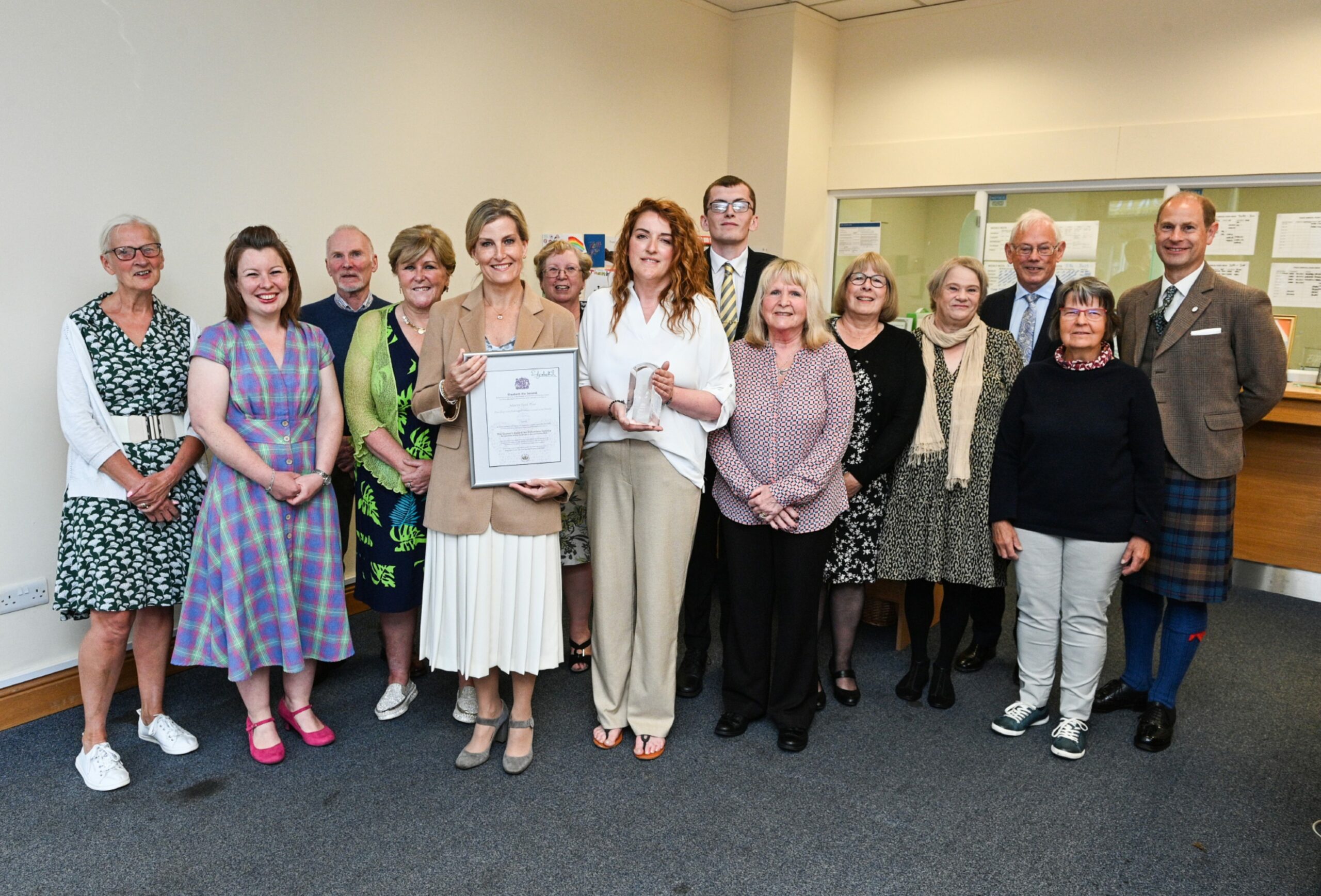 Volunteers at the Moray Food Plus with the prestigious Queen's Award along with the Earl and Countess of Wessex and Forfar. Picture by Jason Hedges.