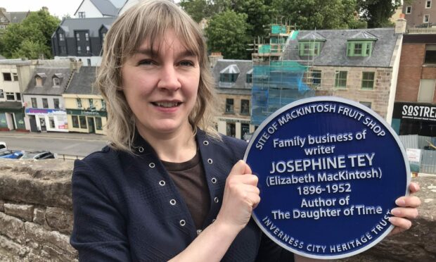 Jennifer Morag Henderson holds the Blue Plaque she has long been campaigning for celebrating Inverness writer Josephine Tey