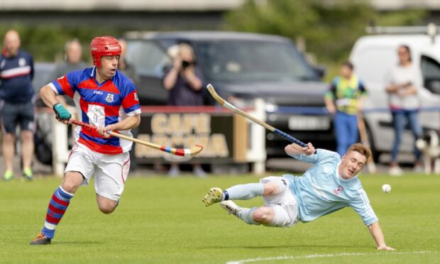 James Hutchison, left, (Kingussie) in action.