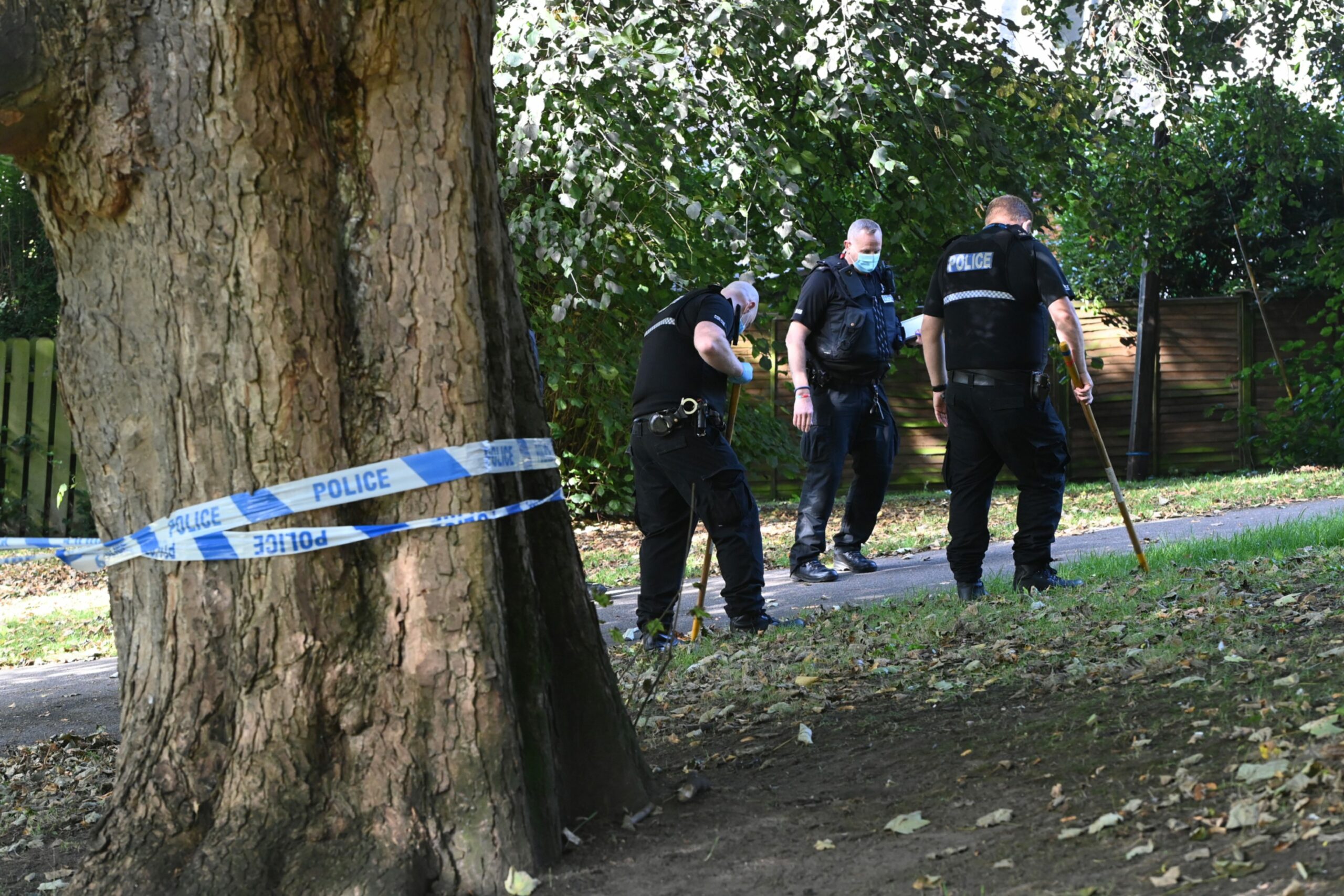 Police officers searching for clues in Bon Accord Terrace Gardens.