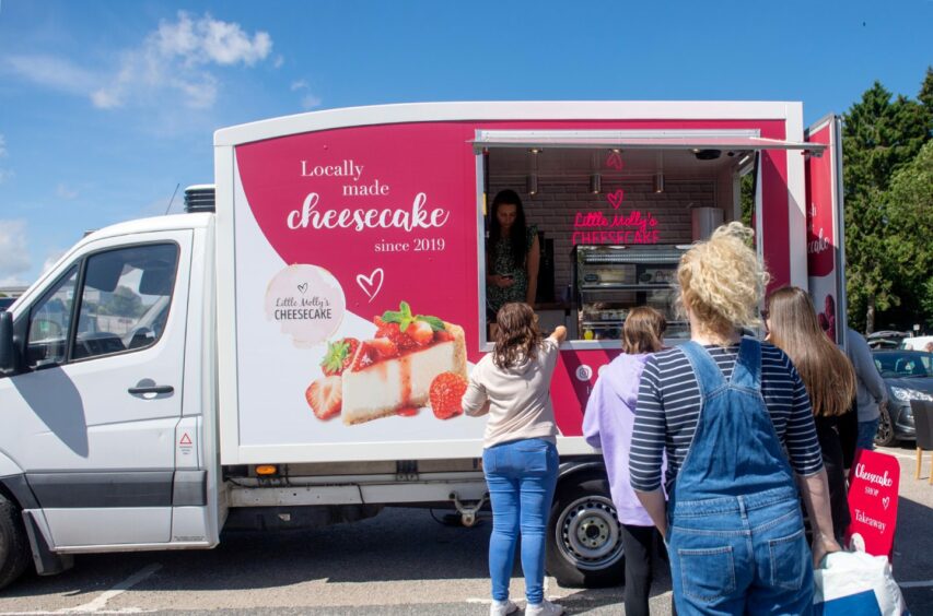 Little Molly's Cheesecake has been operating from a beach front van since 2022, pictured with a queue lined up waiting to be served. 