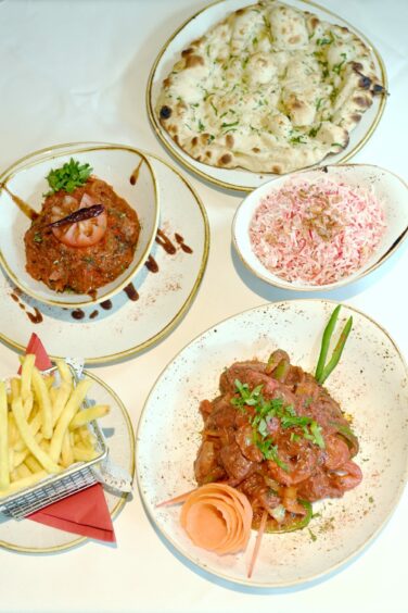 A selection of meals and sides at Echt Tandoori including Khazana chicken, Echt balti special, garlic naan, pilau rice and chips.