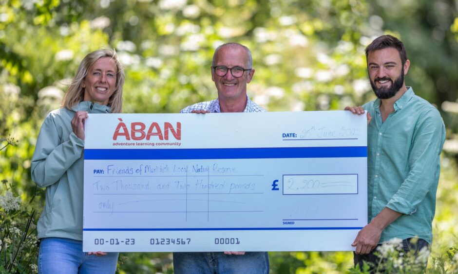 Aban trustee Lynsey Macdonald presenting a cheque of £2,200 to Friends of Merkinch Local Nature Reserve.