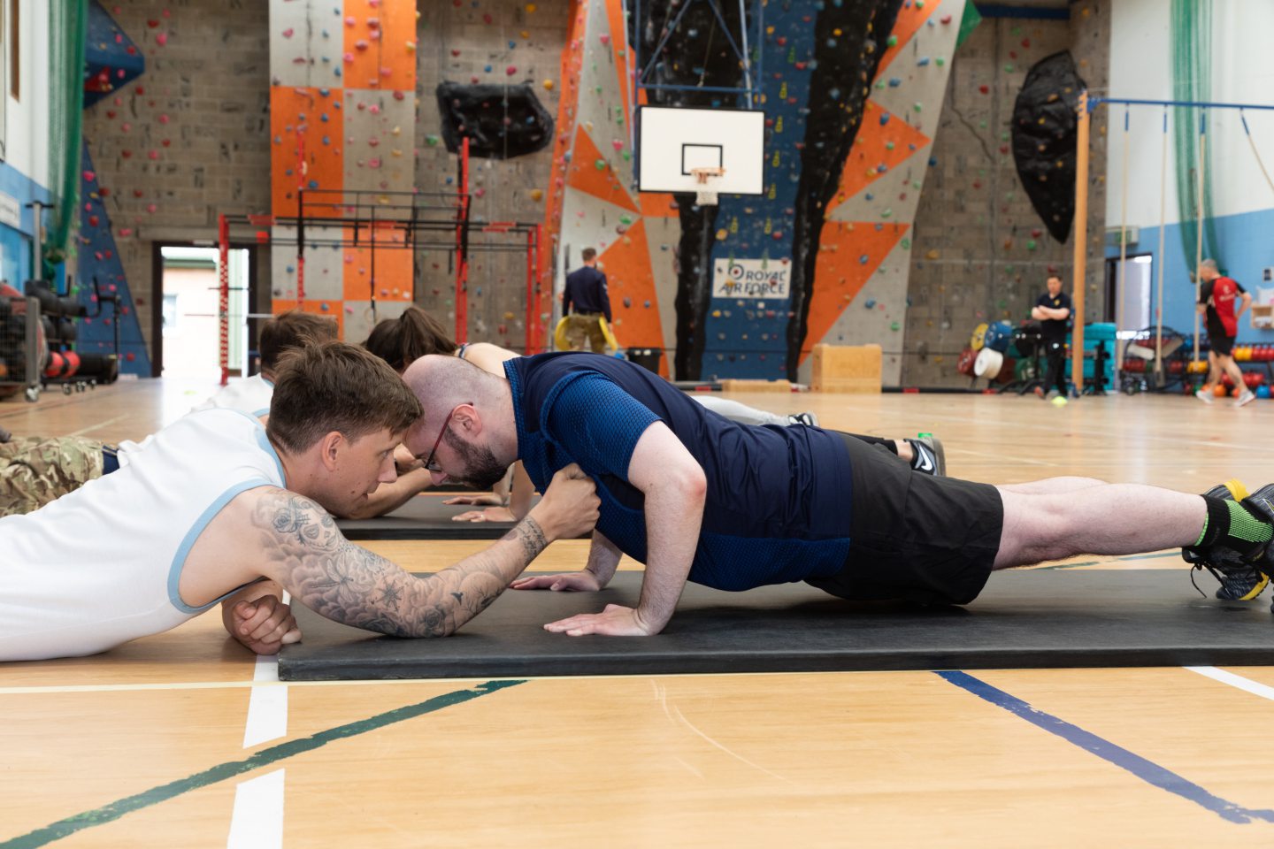 Three people doing press-ups as part of the RAF Lossiemouth fitness test.