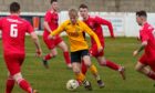 New Huntly signing Adam Morris, centre, in action for Fort William last season