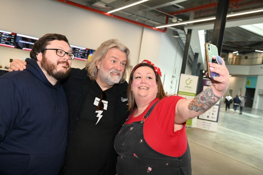 Si King taking a selfie with two festivalgoers at Taste of Grampian.
