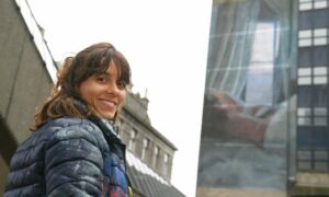 Elisa Capdevila in front of the mural she is painting for Nuart festival in Aberdeen.