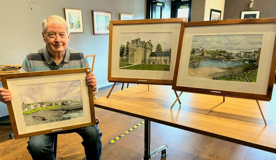John Gerrie with some of his paintings.
