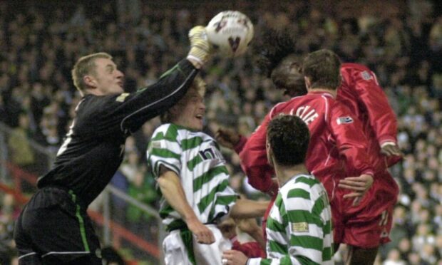 Eugene Dadi  takes on keeper Robert Douglas at Pittodrie in a 2-0 loss in February 2002.