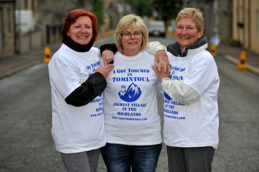 In 2012 Cllr Fiona Murdoch, Dianne Dunlop and Cllr Anne McKay in Moray wear t-shirts reading 'I got torched in Tomintoul'.