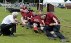 Men playing tug o' war at the Aberdeen Highland Games.