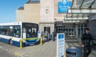 Passengers boarding bus at Elgin bus station.