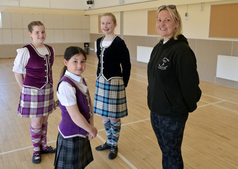 Cheryl Heggie, who has her own dance school, does not believe Highland dancing will fade away unlike other Scottish traditions. Here she stands with three of her pupils.